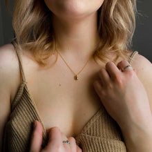Load image into Gallery viewer, model wearing a golden dripple necklace
